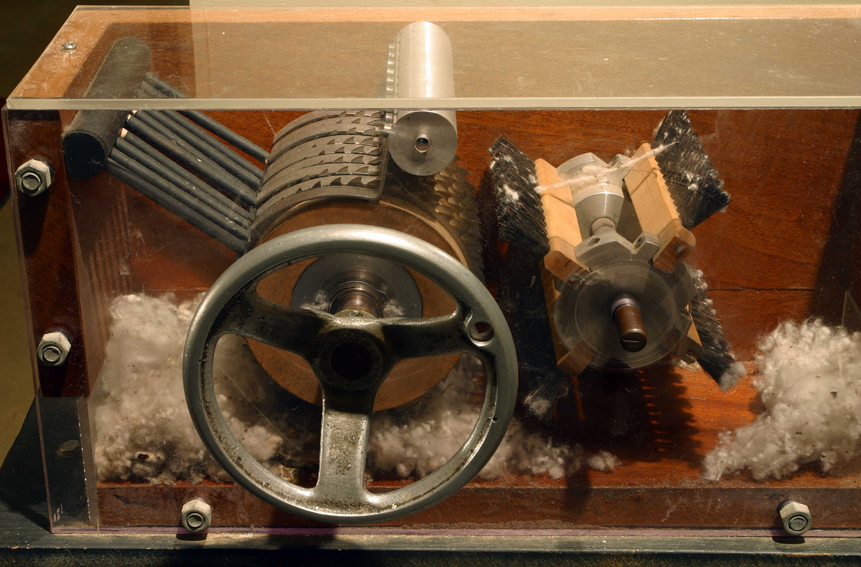 A model of Eli Whitney's cotton gin. By mechanizing the separation of sticky seeds from cotton fibers, the machine removed a processing bottleneck, which inadvertently caused a massive expansion in the demand for enslaved labor to plant and pick the cotton.