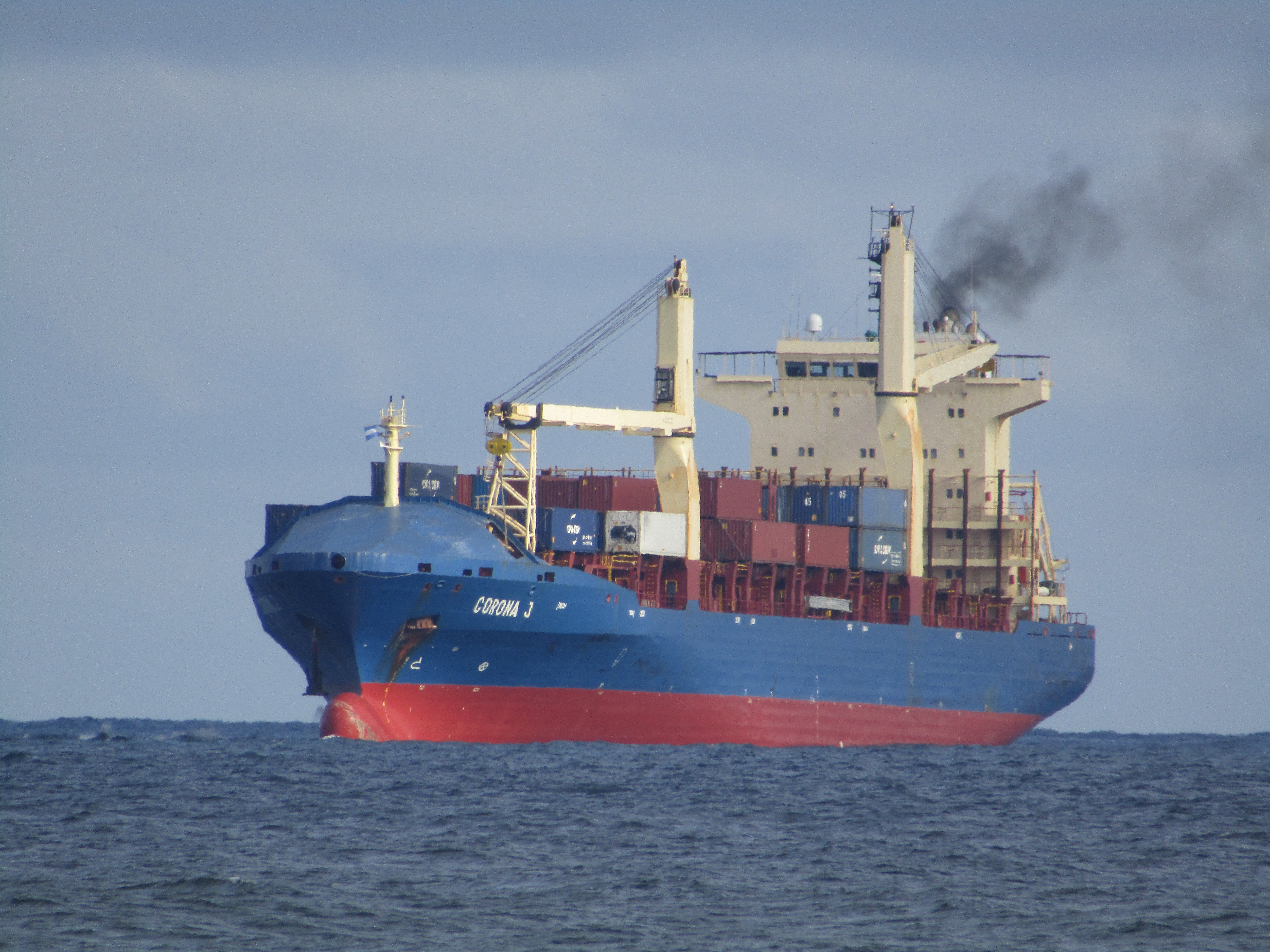 A large commercial cargo ship. Managing a multi-million-dollar real estate asset is conceptually akin to captaining a massive vessel, requiring the manager to navigate volatile market currents, oversee complex physical machinery, and ensure a profitable voyage for the owner.