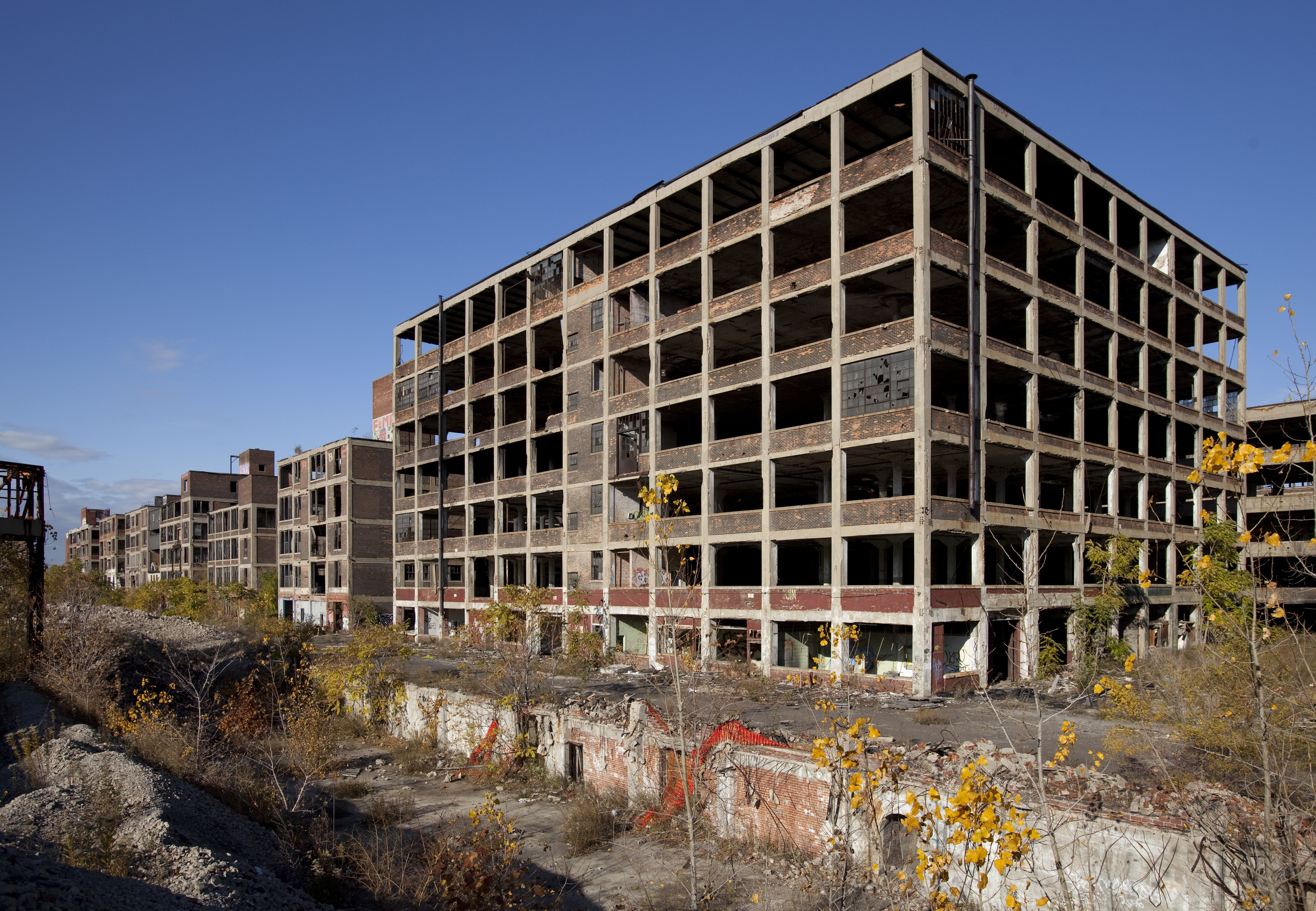 The abandoned Packard Automotive Plant in Detroit serves as a stark spatial artifact of deindustrialization in the American Rust Belt.