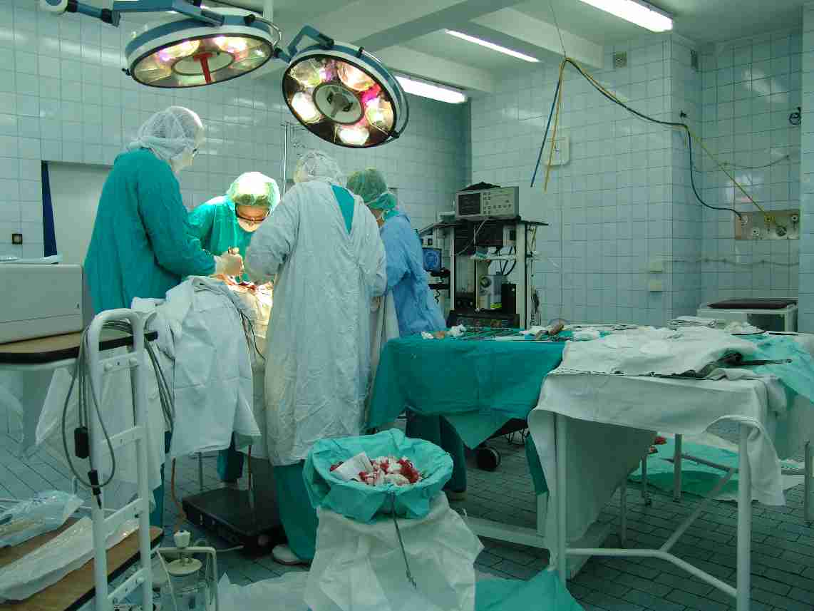 Inside a modern operating theater, where strict geographical boundaries separate the sterile field from the unsterile areas to prevent intraoperative infection.
