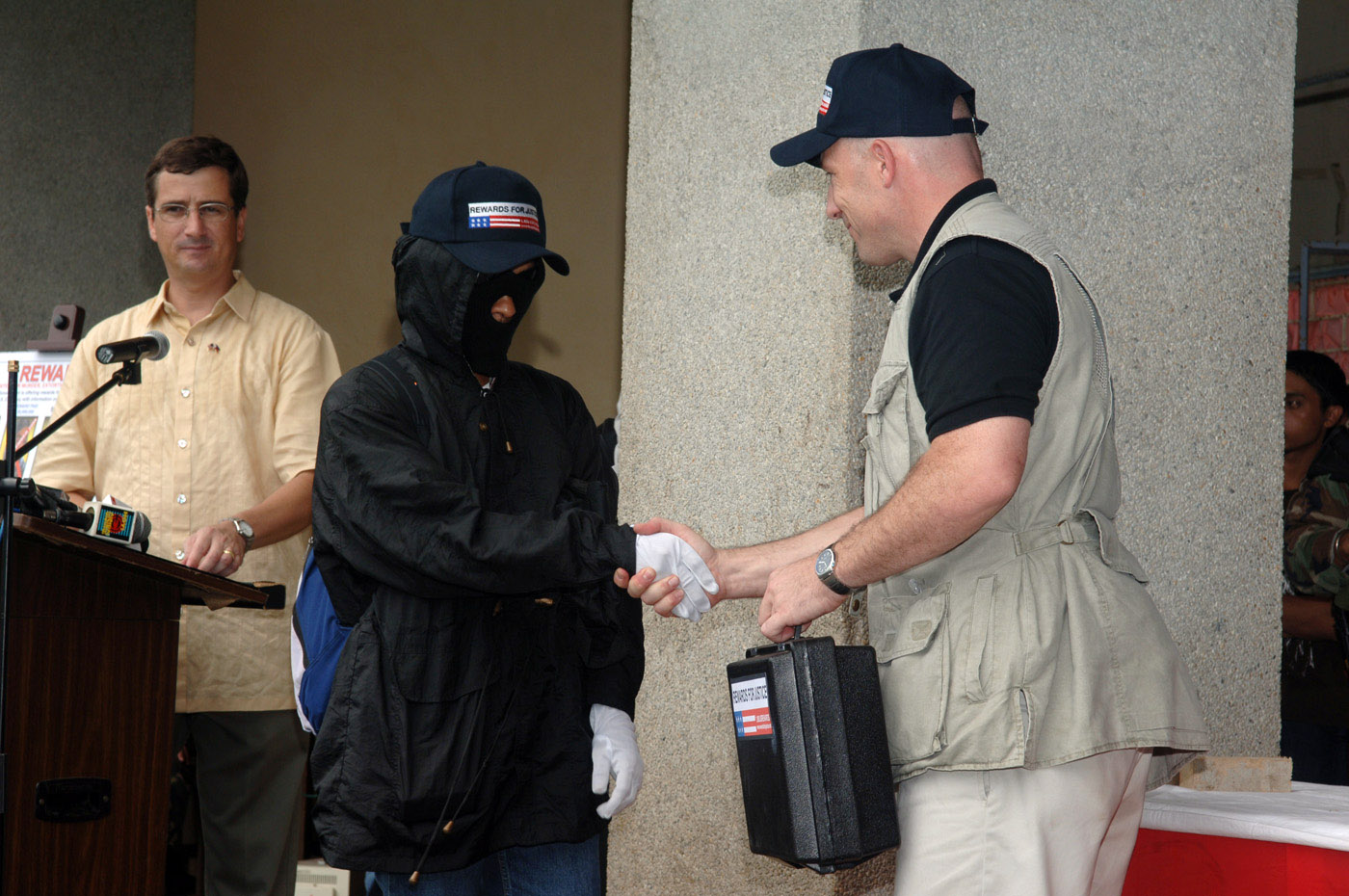 A payment being made to a disguised informant — protecting an informant's identity is the paradigm example of sensitive material the prosecution may seek to withhold via a public interest immunity ruling.