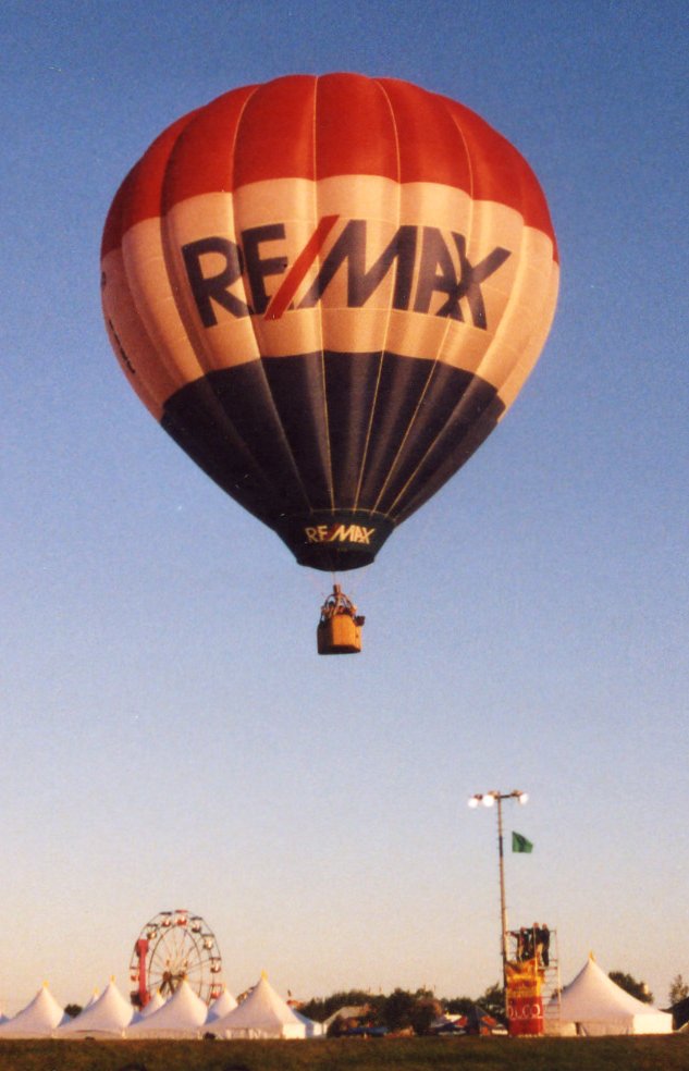 An iconic franchise logo, like the RE/MAX hot air balloon, cannot be used to satisfy Ohio's equal prominence requirement; the actual licensed name of the brokerage must be displayed with equal visual weight to the salesperson's name.