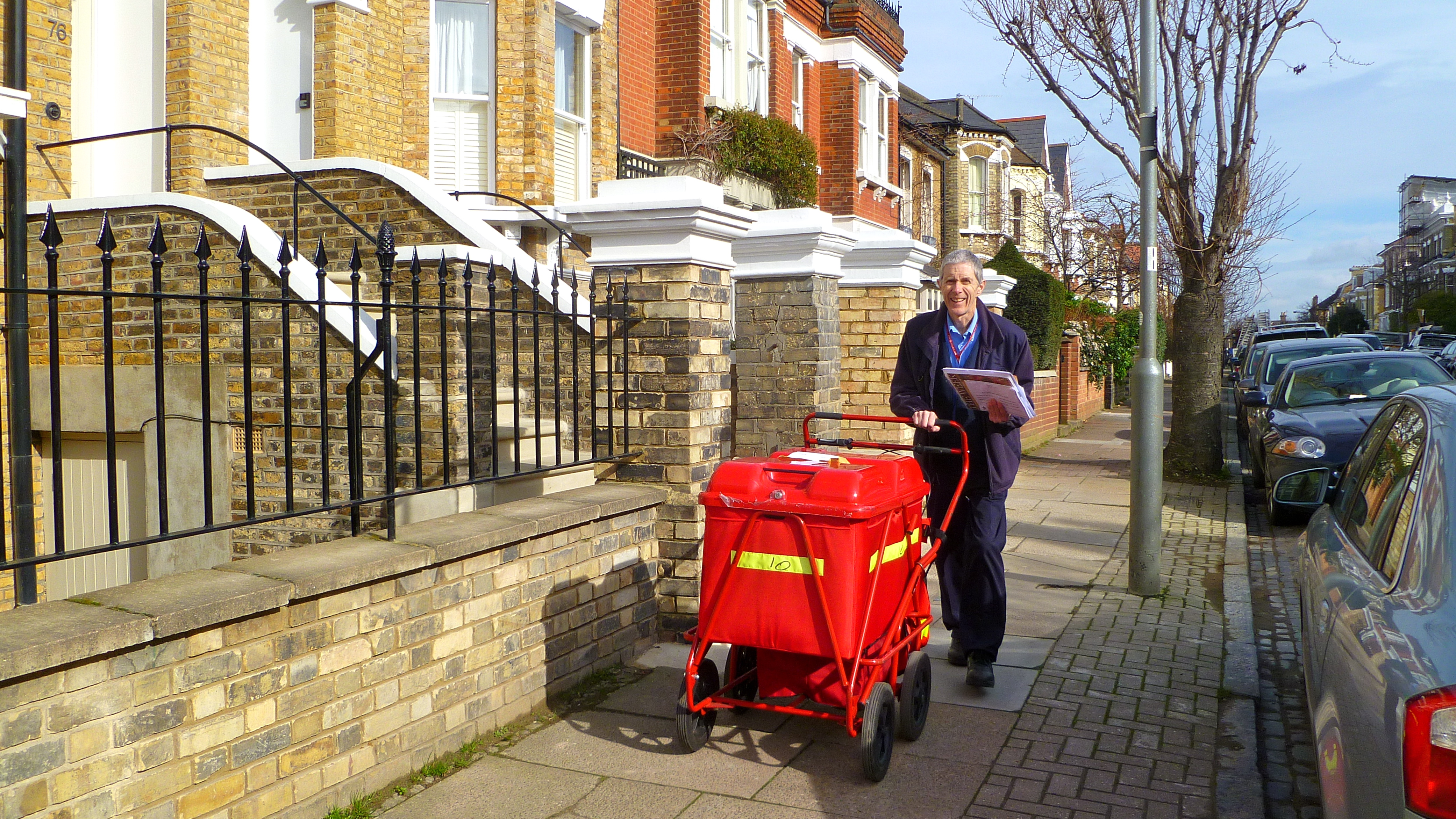 A modern London postman delivering mail on his round — the paradigm lawful visitor, whose claim if injured on the property is governed by the 1957 Act.