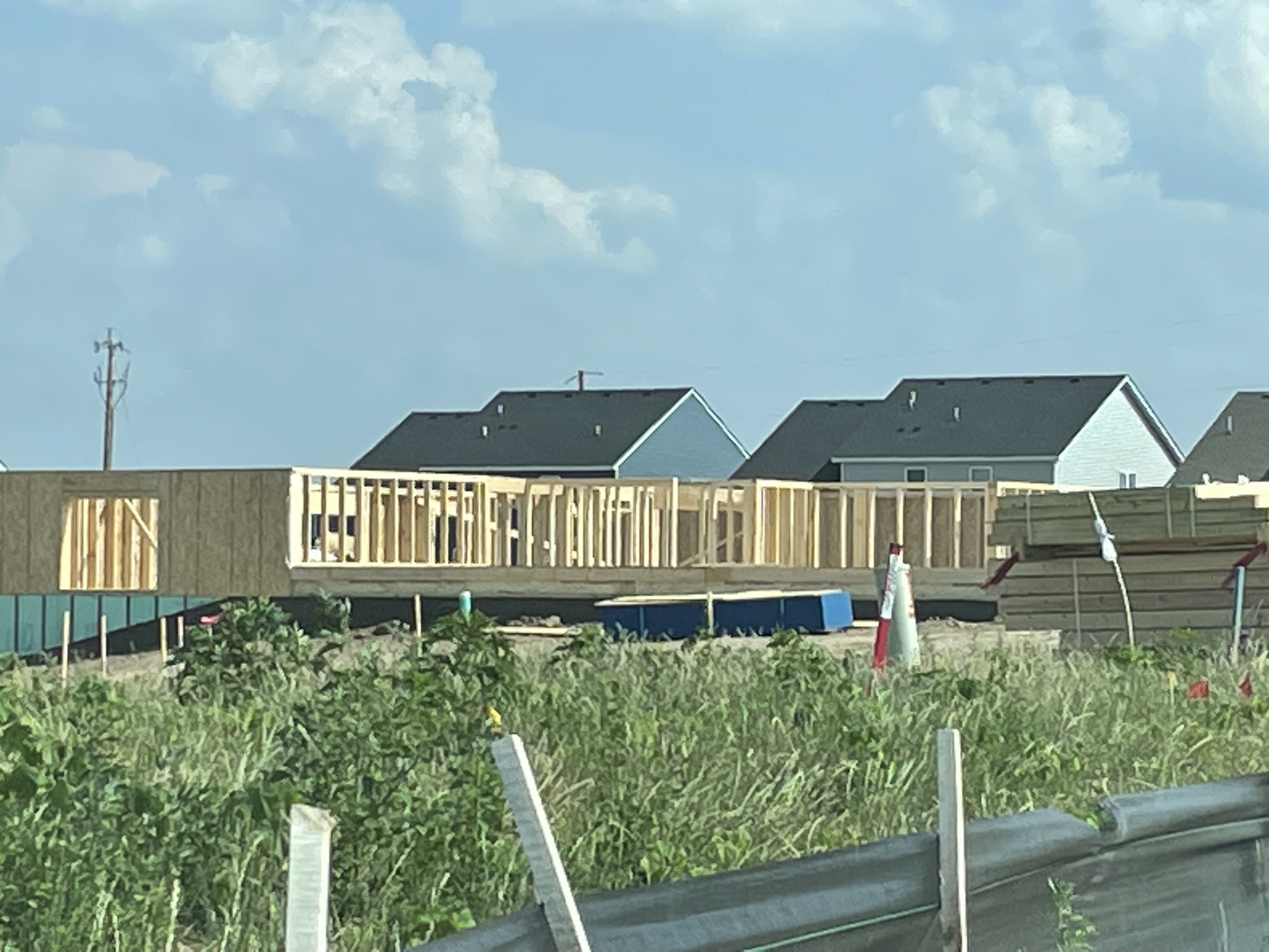 Modern light framing in residential construction, showing vertical wall studs spaced to standard dimensions with horizontal plates at the top and bottom.