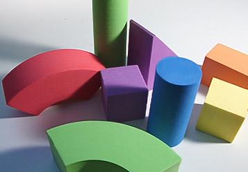 In early childhood special education, play-based materials like wooden blocks serve as foundational tools for organically embedding cognitive and motor skill instruction.