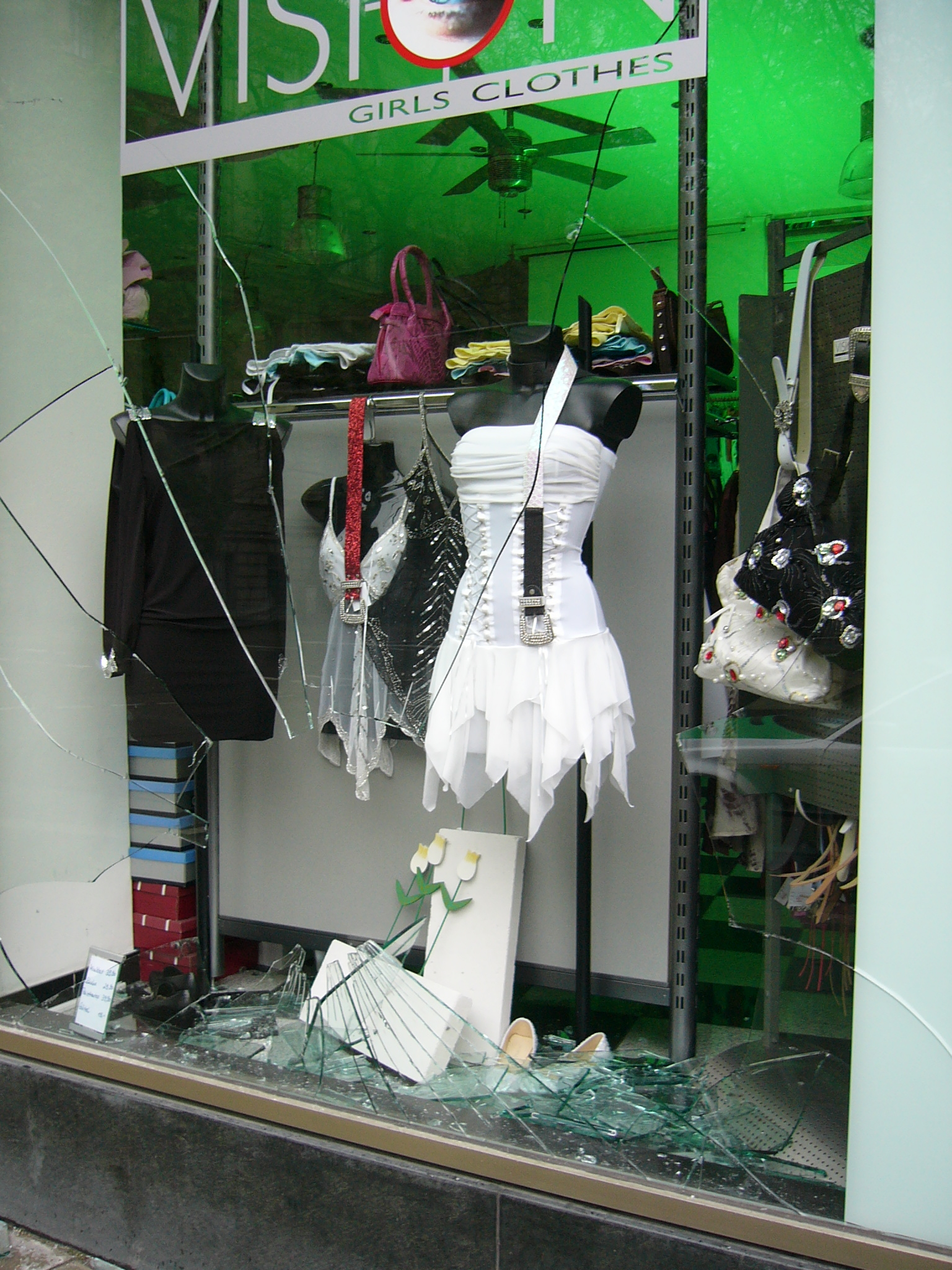 A smashed shop window — the kind of simple criminal damage that stays triable only summarily under section 22 and Schedule 2 of the Magistrates' Courts Act 1980 where the value involved does not exceed £5,000.