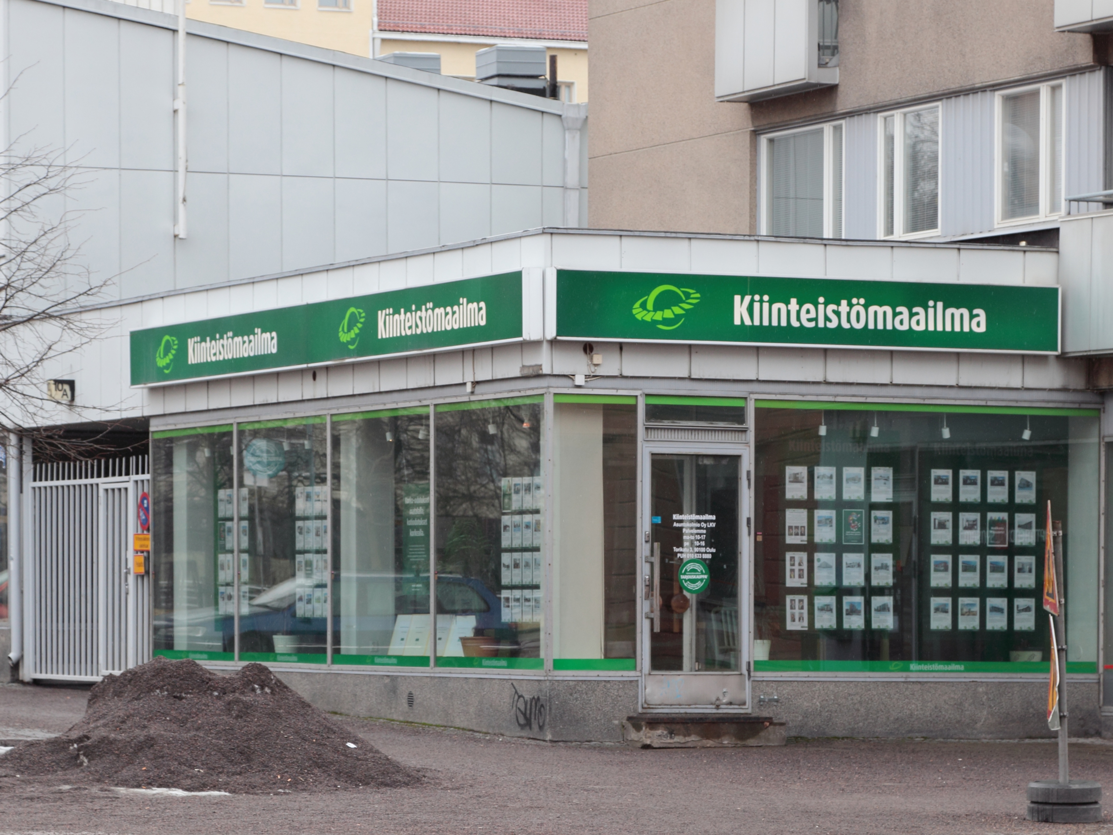 A physical storefront for a real estate agency. Washington law requires every licensed firm to maintain an accessible physical office or records depository within the state to ensure proper public access and regulatory oversight.