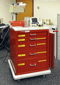 A standard emergency crash cart represents the intense resource concentration dedicated to a single critical patient during everyday hospital operations.