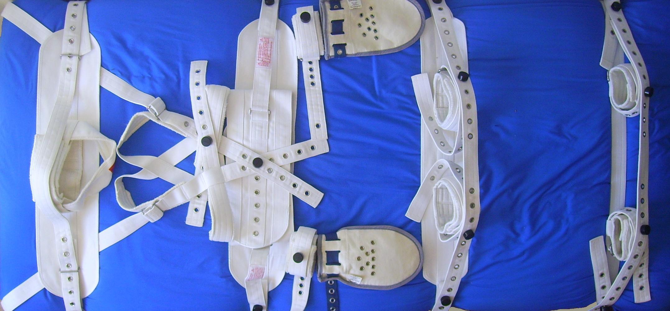 A hospital bed equipped with a full mechanical restraint system. For the NCLEX and clinical practice, physical restraints are strictly an intervention of absolute last resort to prevent immediate, severe harm to the client or staff.